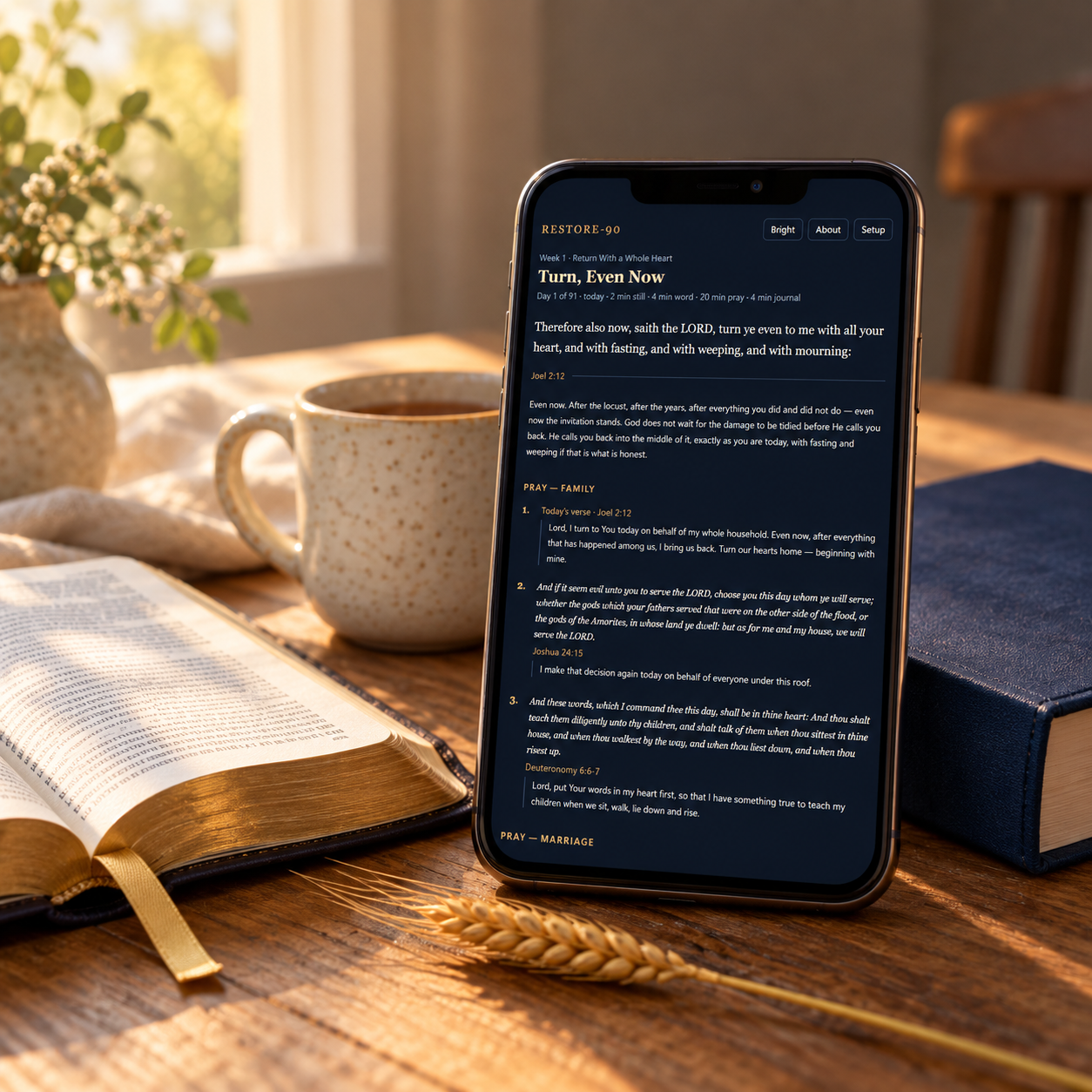 Restore-90 prayer app beside an open Bible and journal